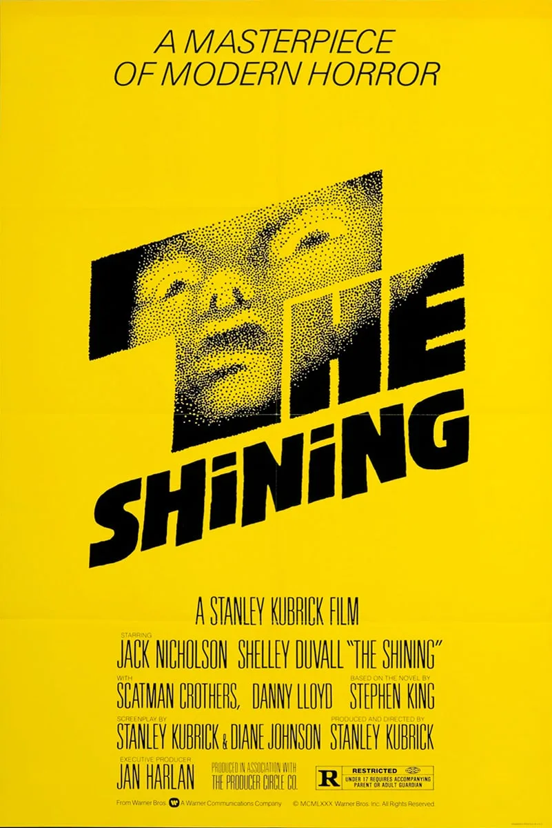 Affiche de "The Shining" conçue par Saul Bass, avec un visage stylisé sur fond jaune vif.